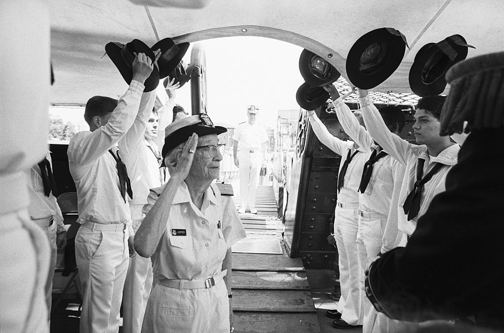 Rear Admiral Grace M. Hopper salutes crew members as she comes aboard the US S Constitution in Boston's Charlestown section for her retirement ceremony 8/14. Hopper, the U. S. Navy's oldest commissioned officer on active duty, retired after serving over 40 years in a Navy uniform. The 188-year-old U. S. S. Constitution is the oldest still commissioned warship afloat in the world.