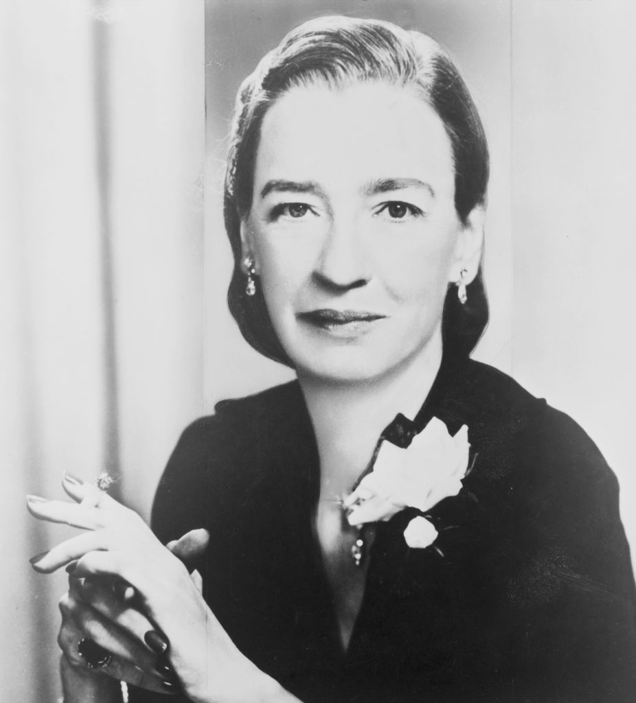 Portrait of Grace Hopper (1906 - 1992), pioneering computer programmer, seated facing front and smoking a cigarette, early 1960s.