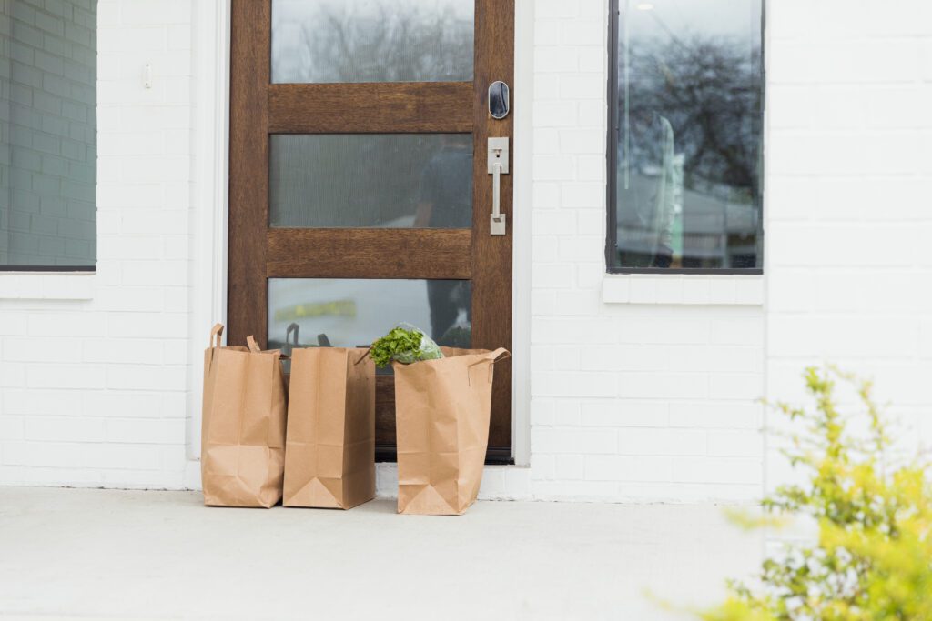 Three paper bags left at front door by delivery person