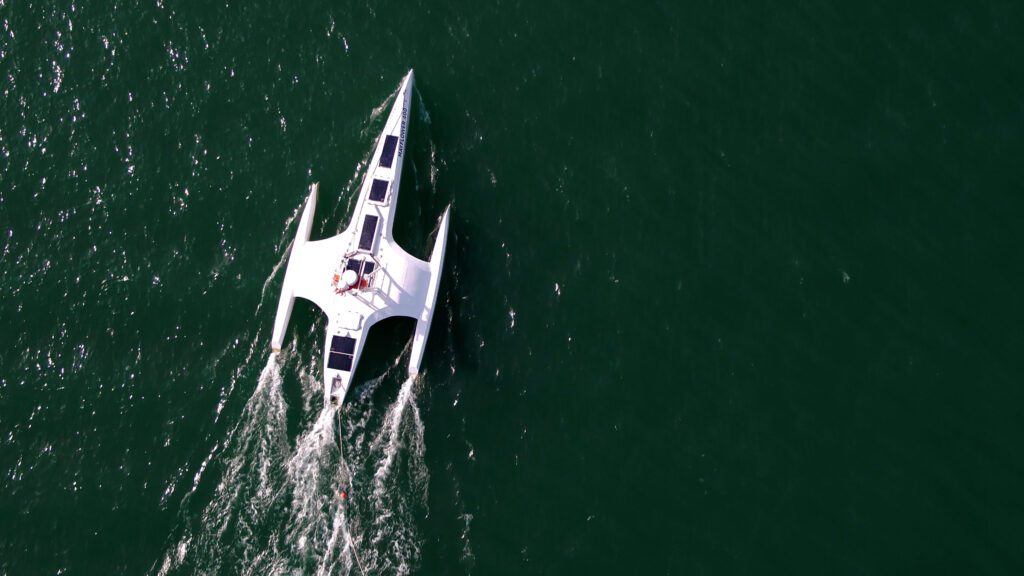 An aerial view of the futuristic looking AI Mayflower ship on the ocean