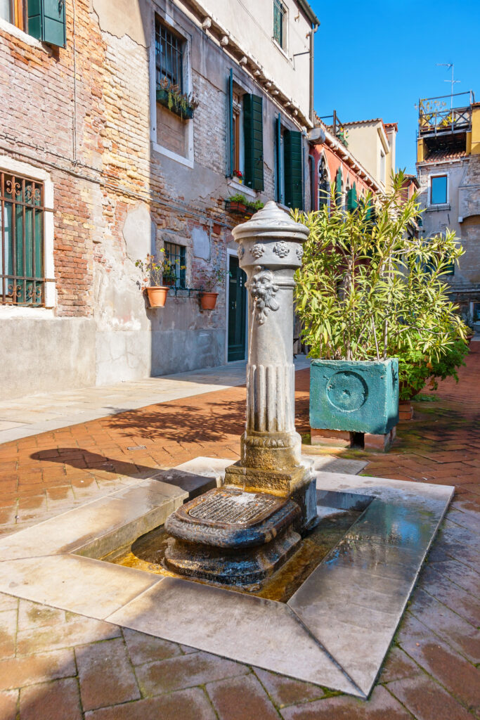 Lion head water fountain on the street. Venice, Italy, Europe