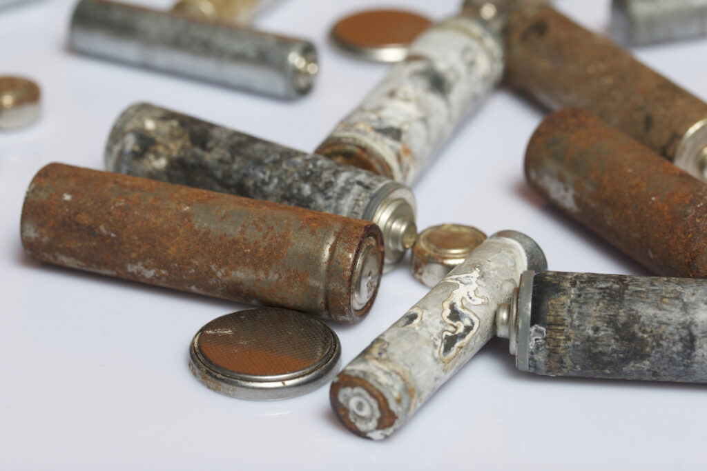 Batteries of different sizes covered with corrosion.