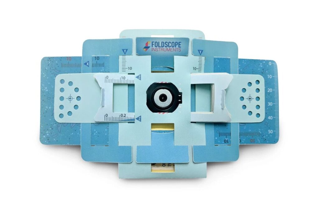 an image of the paper microscope, blue and rectangular, laying flat