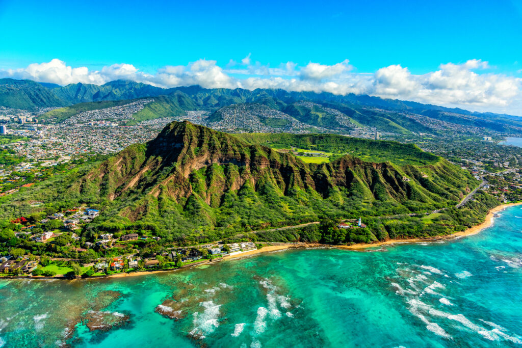 Wide angle aerial view of the majestic Diamond Head volcanic crater towering over the suburbs of Honolulu, Hawaii.