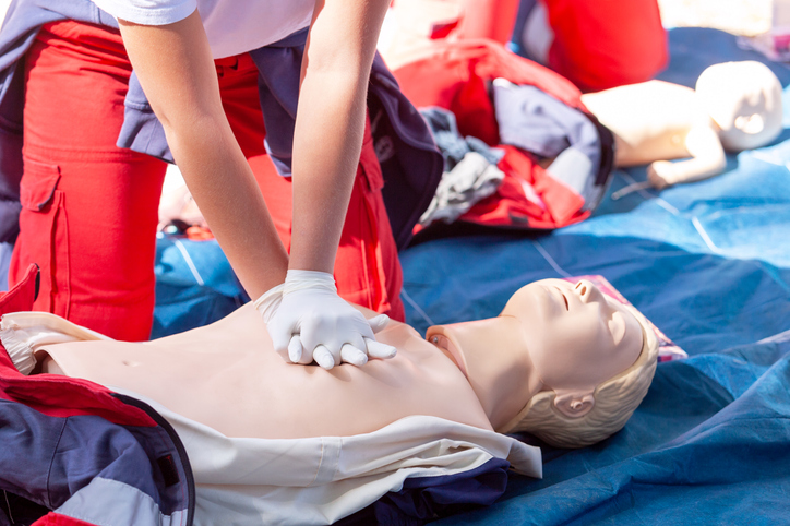 hands press down on a dummy during first aid and Cardiopulmonary resuscitation - CPR training