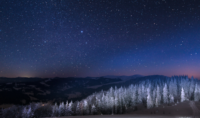 Snowy view of the January night sky over snowy Carpathian Mountains