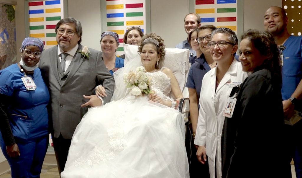Ray and Norina Navarro stand with doctors, nurses and the chaplain in married them at the hospital