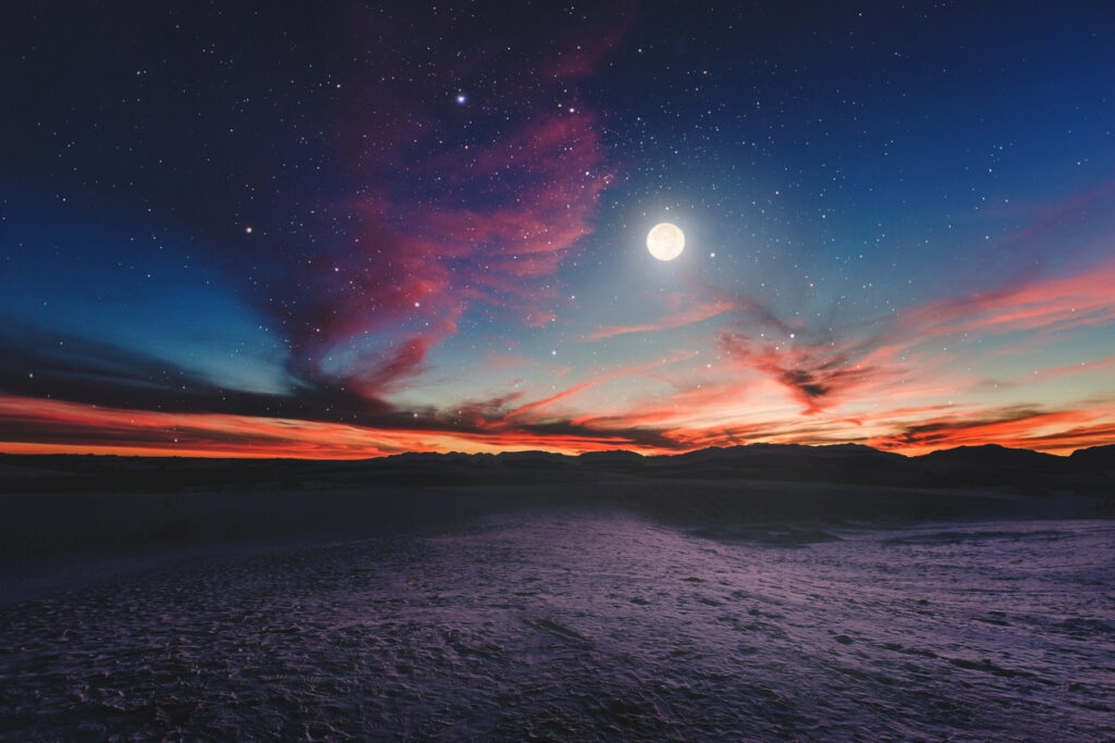 a full moon and a sunset over the march night sky
