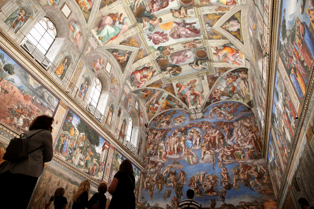 Visitors view the Sistine Chapel frescoes at the Vatican Museum