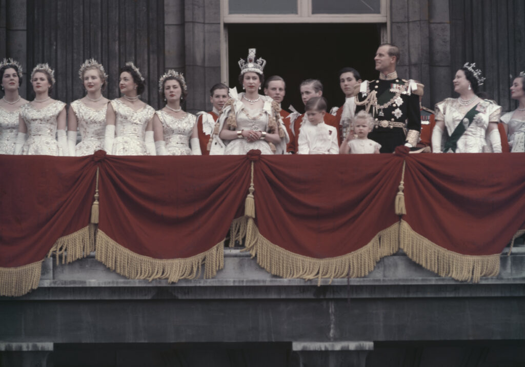 Queen Elizabeth II and the Duke of Edinburgh wave at the crowds from the balcony of Buckingham Palace in London, after Elizabeth's coronation, 2nd June 1953. With them are their children Prince Charles and Princess Anne, and the Queen Mother (1900 - 2002, right). On the left are the maids of honour (left to right) Lady Moyra Hamilton (later Campbell), Lady Jane Heathcote-Drummond-Willoughby, Lady Anne Coke, later Lady Glenconner, Lady Mary Baillie-Hamilton and Lady Jane Vane-Tempest-Stewart.