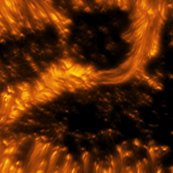 A detailed example of a light bridge crossing a sunspot’s umbra. In this picture, the presence of convection cells surrounding the sunspot is also evident. Hot solar material (plasma) rises in the bright centers of these surrounding “cells,” cools off, and then sinks below the surface in dark lanes in a process known as convection. The detailed image shows complex light bridge and convection cell structures on the Sun’s surface or photosphere. Light bridge: A bright solar feature that spans across an umbra from one penumbra to the other. It is a complex structure, taking different forms and phases, and is believed to be the signature of the start of a decaying sunspot. Umbra: Dark, central region of a sunspot where the magnetic field is strongest.