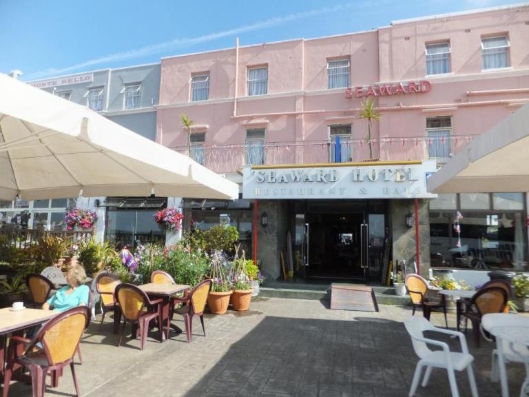 The Seaward hotel on a sunny day with plants and chairs out front