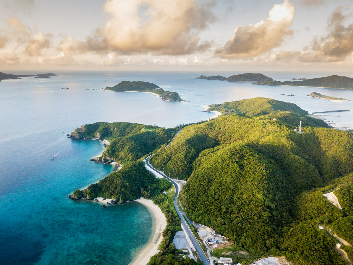 An aerial view over islands with beautiful water and reef surrounding them. From the Kerama island chain in Okinawa, Japan.