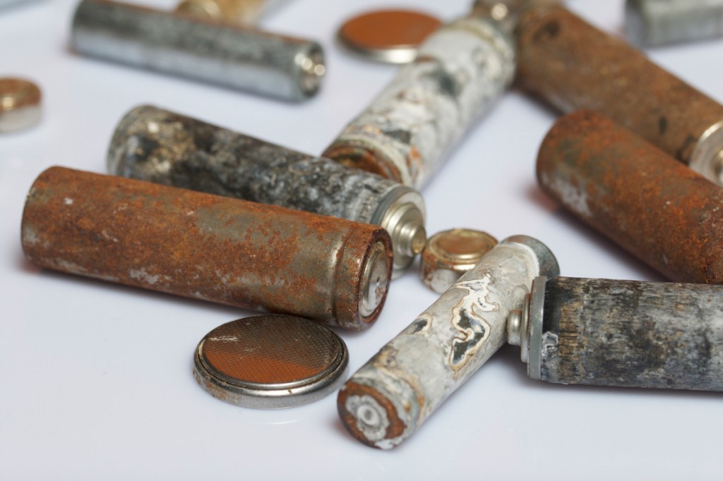 Batteries of different sizes covered with corrosion.