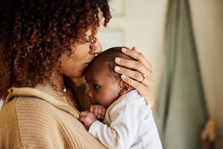 mother soothing her baby in her arms