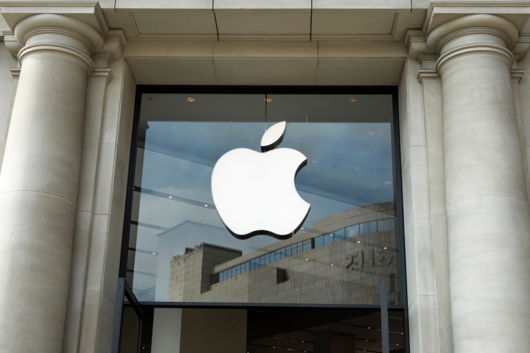 The Apple logo on a glass at the Apple store at Catalonia Square (Plaza Catalunya) in Barcelona in a neoclassic architecture building.