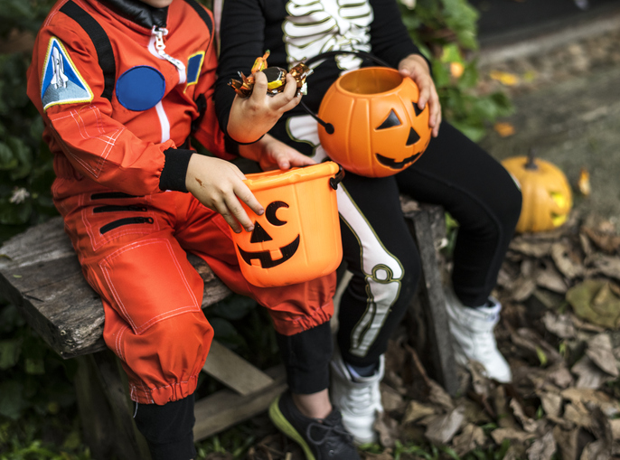 Children in costumes trick or treating on Halloween