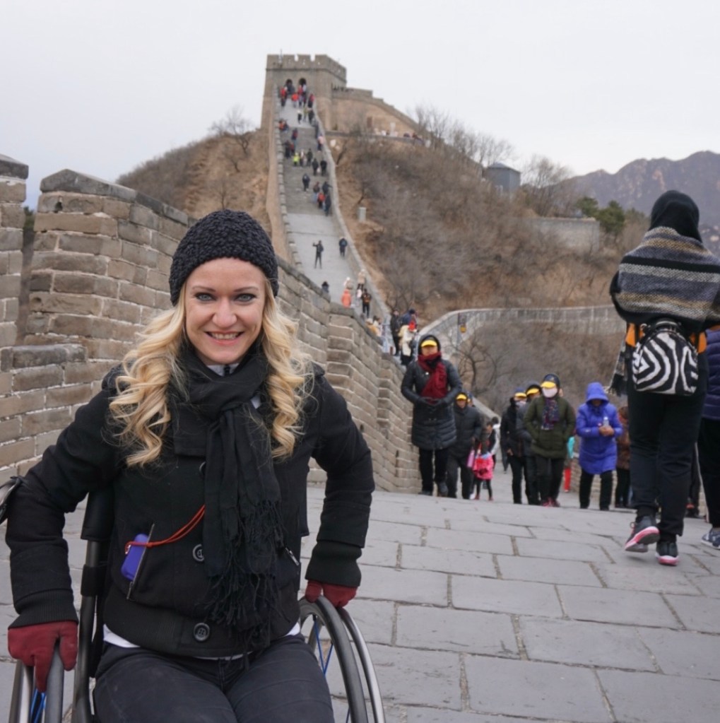 Renee Bruns in front of the steps that lead to the Great Wall of China