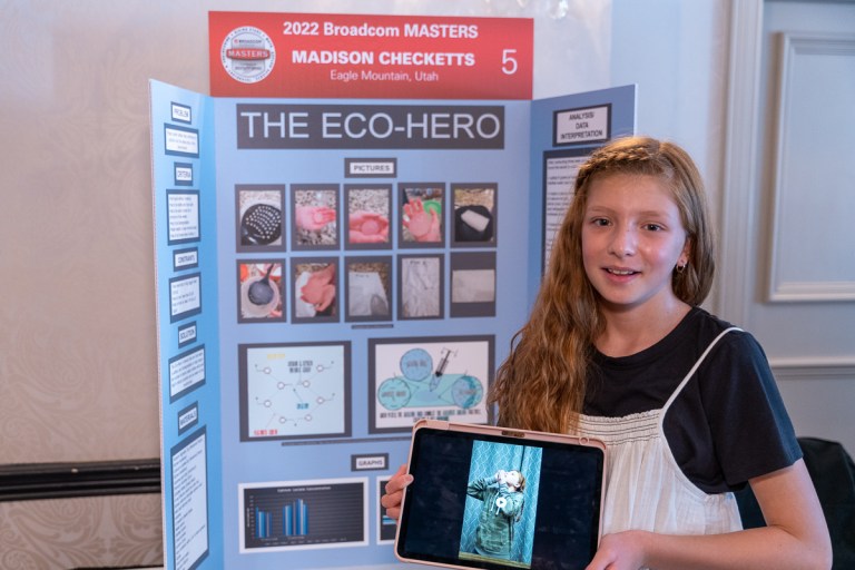 Madison Checketts stands in front of her poster board presentation of her edible water bottle